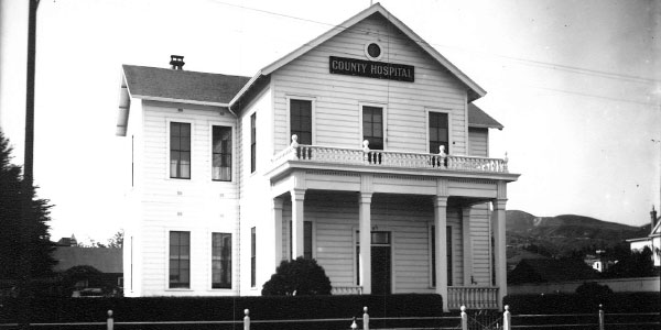 black and white image of the front of the old County Hospital